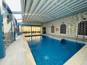 Indoor pool, open 7:00 AM to 10:00 PM, sun loungers, lifeguards on site