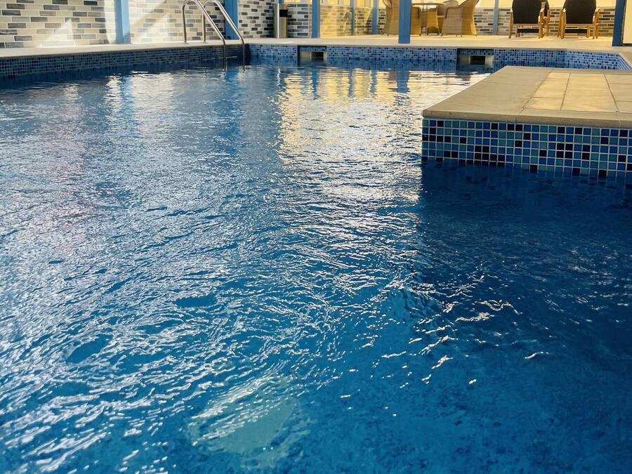 Indoor pool, open 7:00 AM to 10:00 PM, pool loungers, lifeguards on site