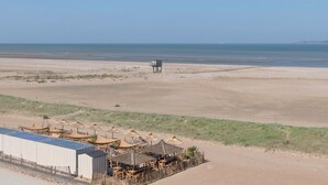 A beachside hotel with outdoor seating and a lifeguard tower. - Facing the sea -  apartment for 2 (Saint-Brevin-les-Pins)