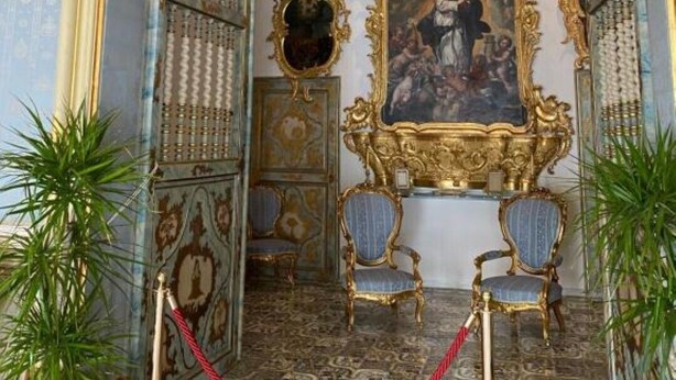An ornate room with a large, gilded painting, two blue upholstered chairs, and patterned floor tiles. - Rambla Apartment by the Sea (Alicante (Alacant))
