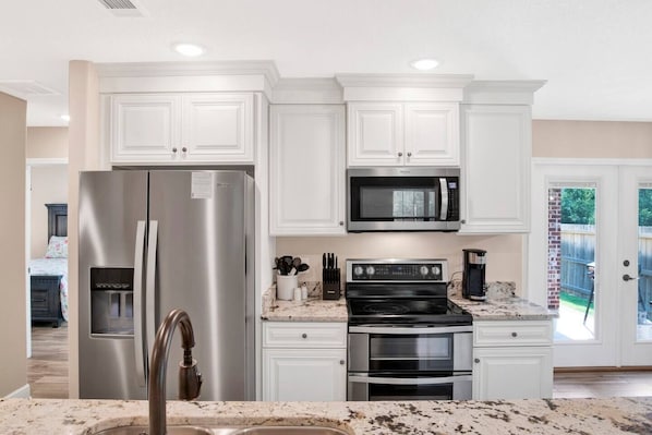 Enjoy cooking in this well-equipped kitchen with a refrigerator, microwave, stove, and oven.