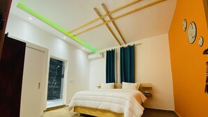 A bedroom with a bed, a window with curtains, an air conditioning unit, and a wooden ceiling structure. - FILYS HÔTEL (St. Louis)