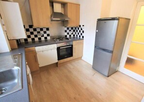 Enjoy cooking in this well-equipped kitchen with a stainless steel refrigerator, oven, and dishwasher.