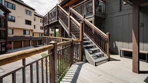 A multi-story building with a wooden staircase and balcony railing. - NLTH3 | Mountain Living | Ski Out/Walk In | Winter Shuttle | Hot Tub (Steamboat Springs)