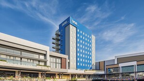 A modern hotel with a prominent blue and white facade, featuring a large number of windows and a flat roof. - One Mazatlán (Mazatlán)