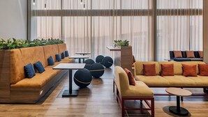 Un espace de détente moderne comprenant un canapé, une petite table et un banc.