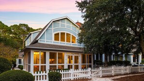 A two-story house with a white picket fence, a covered front porch, and a large tree to the right. - Golf Cart | 500 Yards to Beach | Bikes (Watersound)