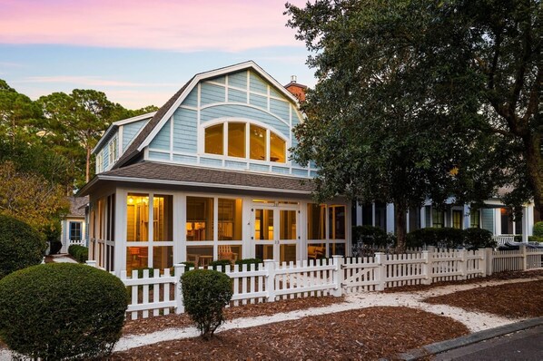 A two-story house with a white picket fence, a covered front porch, and a large tree to the right. - Golf Cart | 500 Yards to Beach | Bikes (Watersound)