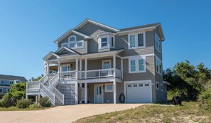 A two-story house with a front porch, a staircase, and a garage.