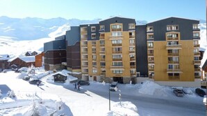 Een hotel met meerdere verdiepingen, met een modern design, balkons en grote ramen.