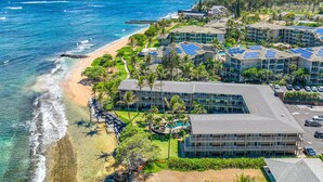 A coastal hotel with multiple buildings, a beach, and ocean views. - Kailani #314, Top Floor, Walk to Kapaa Town and Beach (Kapaa)