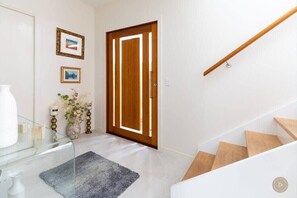 Enter a clean and contemporary space with a glass console table and decorative accents.