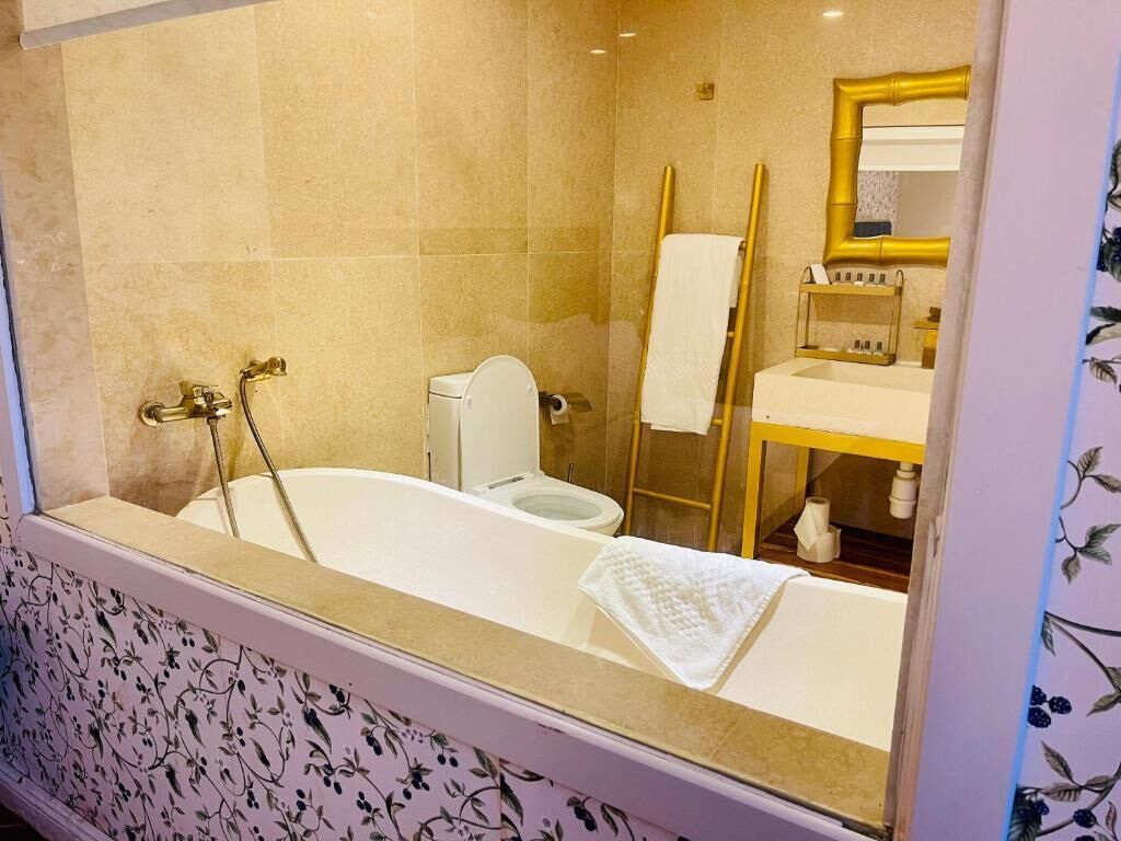 A bathroom with a bathtub, toilet, and sink.