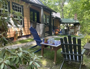 Relax in a serene garden setting with a patio, fire hydrant, and charming gazebo.