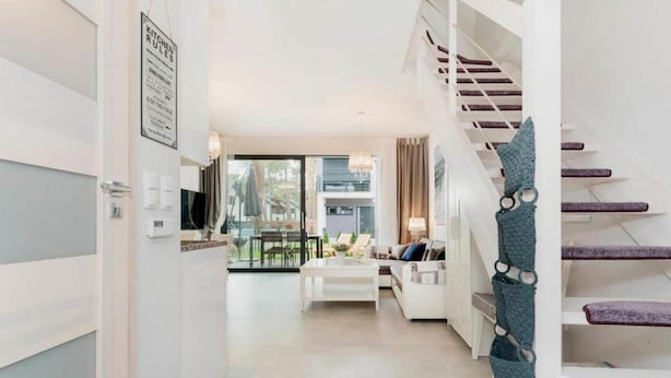 A modern interior with a staircase, a dining area, and a living room. - Comfortable holiday home with garden, summer pool (Pobierowo)