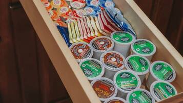 A drawer filled with various food items, including jars and containers, likely in a kitchen setting.