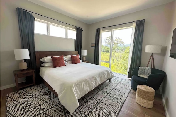Relaxing master bedroom, with great light and views of mountains and river.