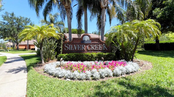 Welcome to Silver Creek, surrounded by lush landscaping and manicured gardens.