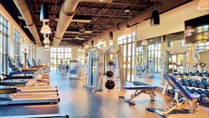 A gym with treadmills, weight machines, and dumbbells. - South Pool | Game Room | 7 Miles to Disney 1504 (Kissimmee)