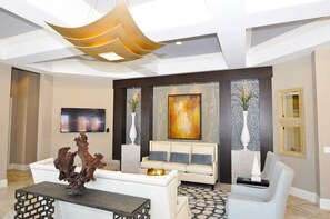 Relax in this stylish living room with a sofa, coffee table, and flat-screen TV.