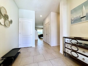 Stylish hallway with white doors, a black bench, and a console with drawers.