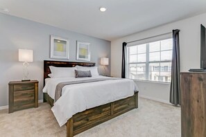 A bedroom with a bed, nightstands, a dresser, and a window with curtains. - Star Wars | Princess | Mickey | Pool | Disney 7036 (Davenport)