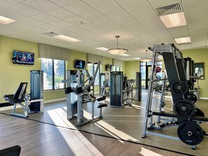 A gym with exercise equipment, a television, and large windows. - Privacy Pool! Game Room! Resort 6 mi 2 Disney-2707 (Kissimmee)