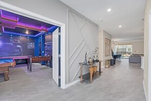 Relax and socialize in a spacious living area with a sofa and chairs, or challenge friends to a game of foosball or pool.