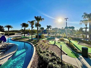 A pool with a 3ft 9in depth marker, a golf course, palm trees, and a clear sky. - Value! Clean! Lazy River-Resort 6 mi 2 Disney-4228 (Kissimmee)
