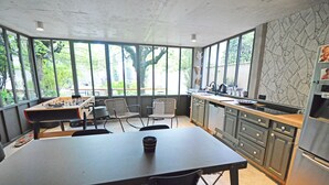 A kitchen with a dining table, chairs, and a foosball table. - Villa Piscine, Jardin Arboré, Proche Centre Ville (Montélimar)