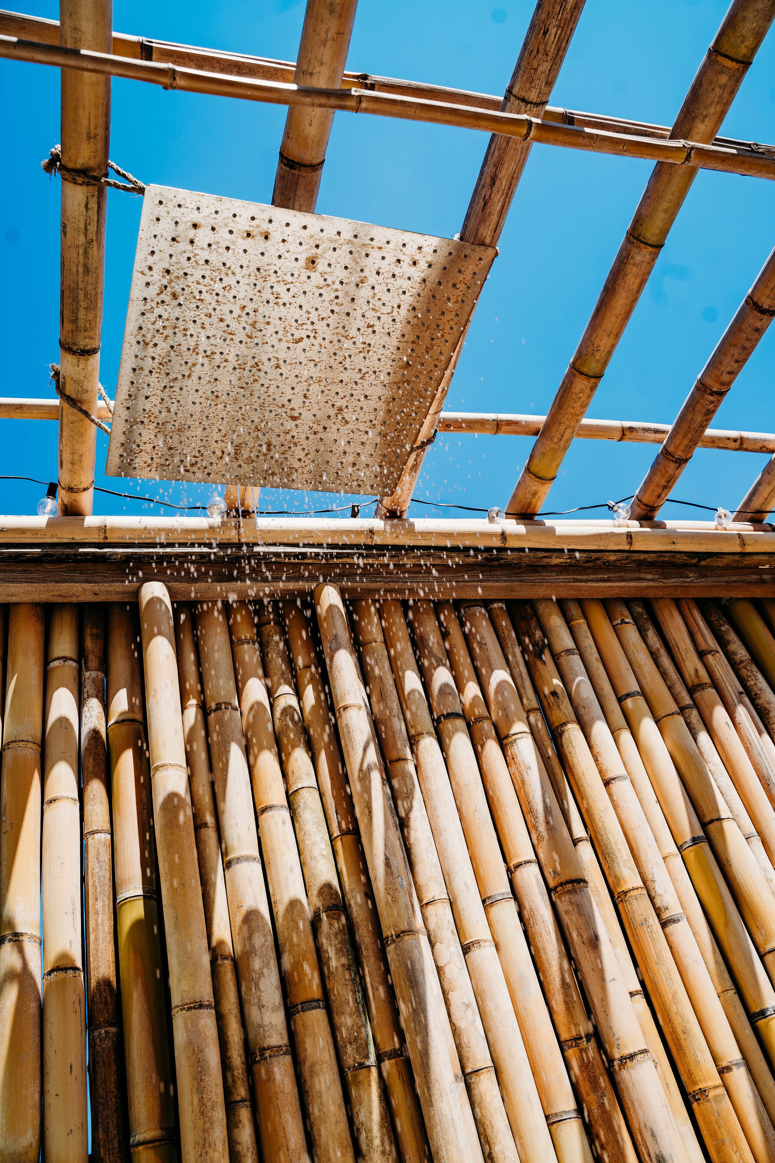 A bamboo structure with a perforated panel.