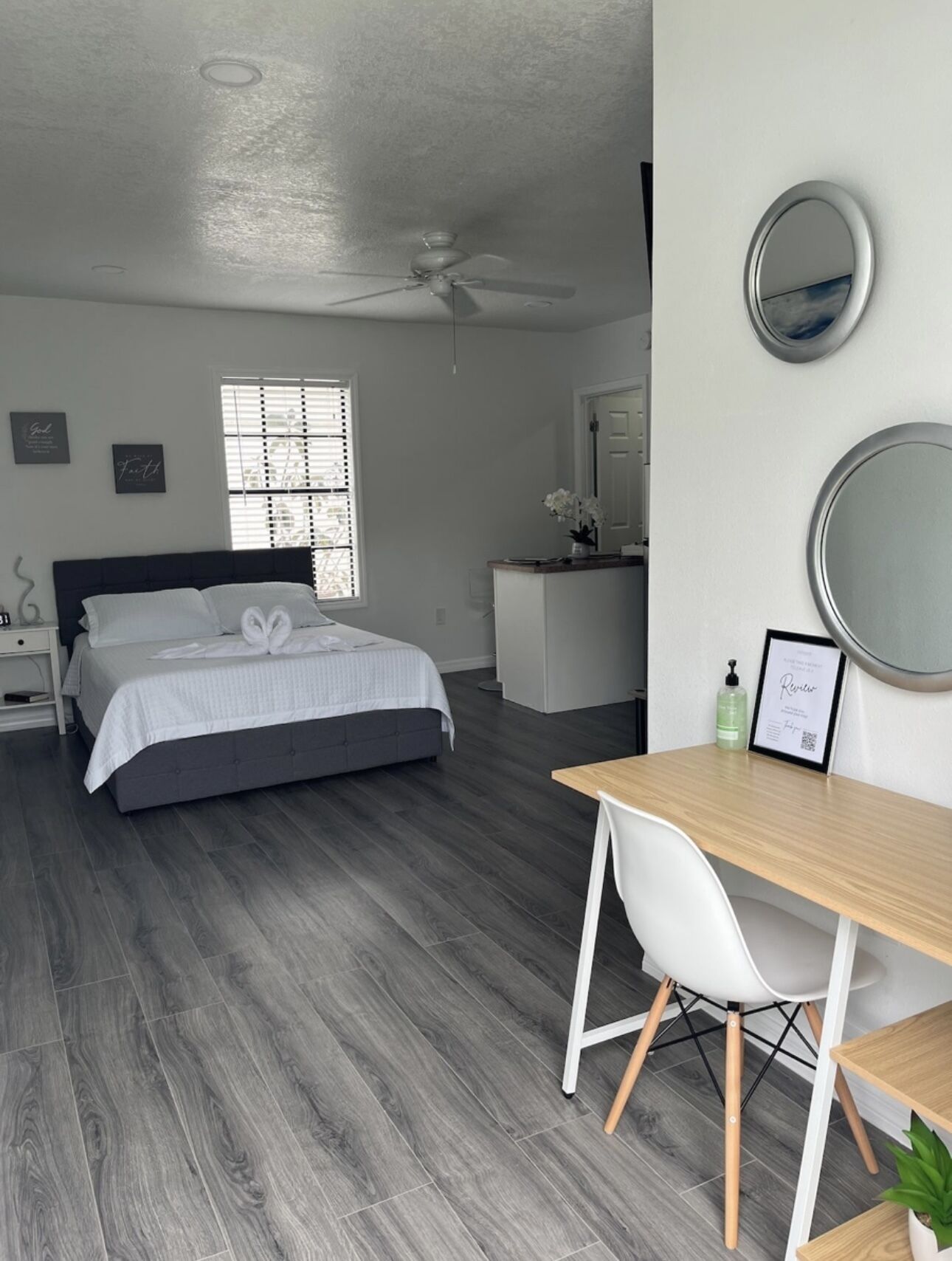 Une chambre moderne avec un lit, une table de chevet et un bureau avec une chaise.