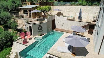 Relax by the pool surrounded by lush greenery and enjoy the scenic views.