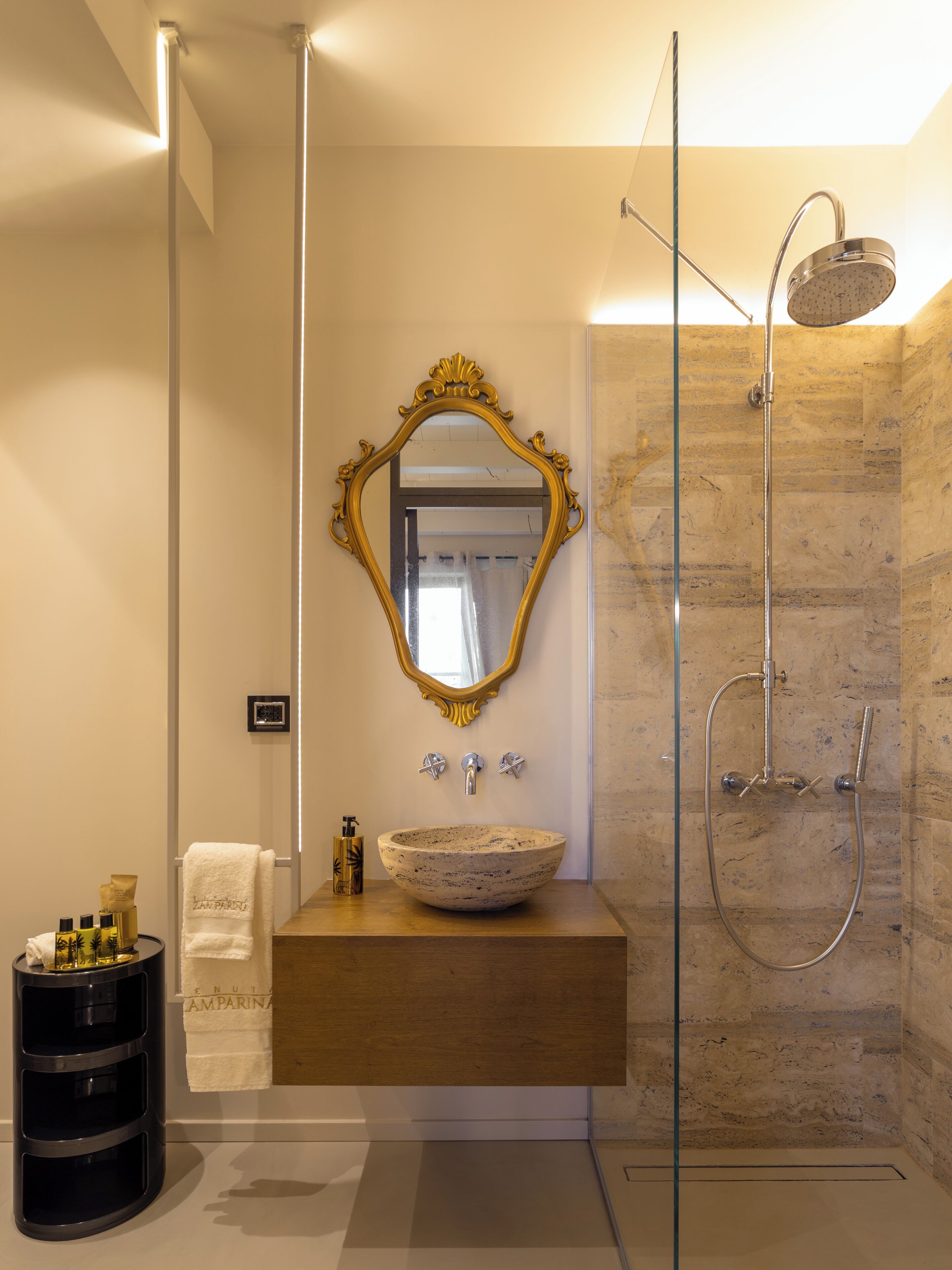 A modern bathroom with a freestanding bathtub, a large mirror, and a wooden vanity.