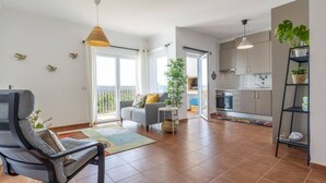 A modern apartment with a living area, kitchen, and balcony. - Beach & Nature Apartmentn in Aljezur by Lisbeyond (Aljezur)