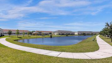 A courtyard with a central pond, surrounded by buildings with a uniform architectural style.