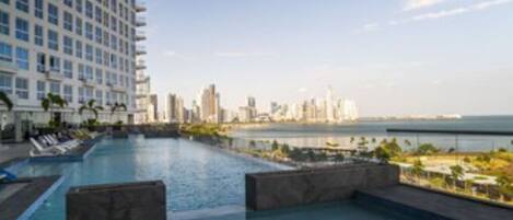 Relax by the rooftop pool with a stunning city view.