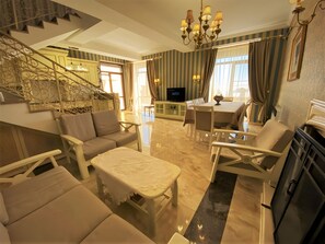 Deluxe Villa | Living area | 32-inch Smart TV with cable channels, TV, DVD player