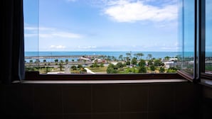 A view from a window overlooking a coastal area with a marina, playground, and greenery. - Grand Family Home (Trabzon)