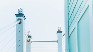 A set of white steps leading up to a building with a light blue exterior. - Waterfront with spectacular views, peaceful and private duplex, fishermens dream (Beaufort NC)