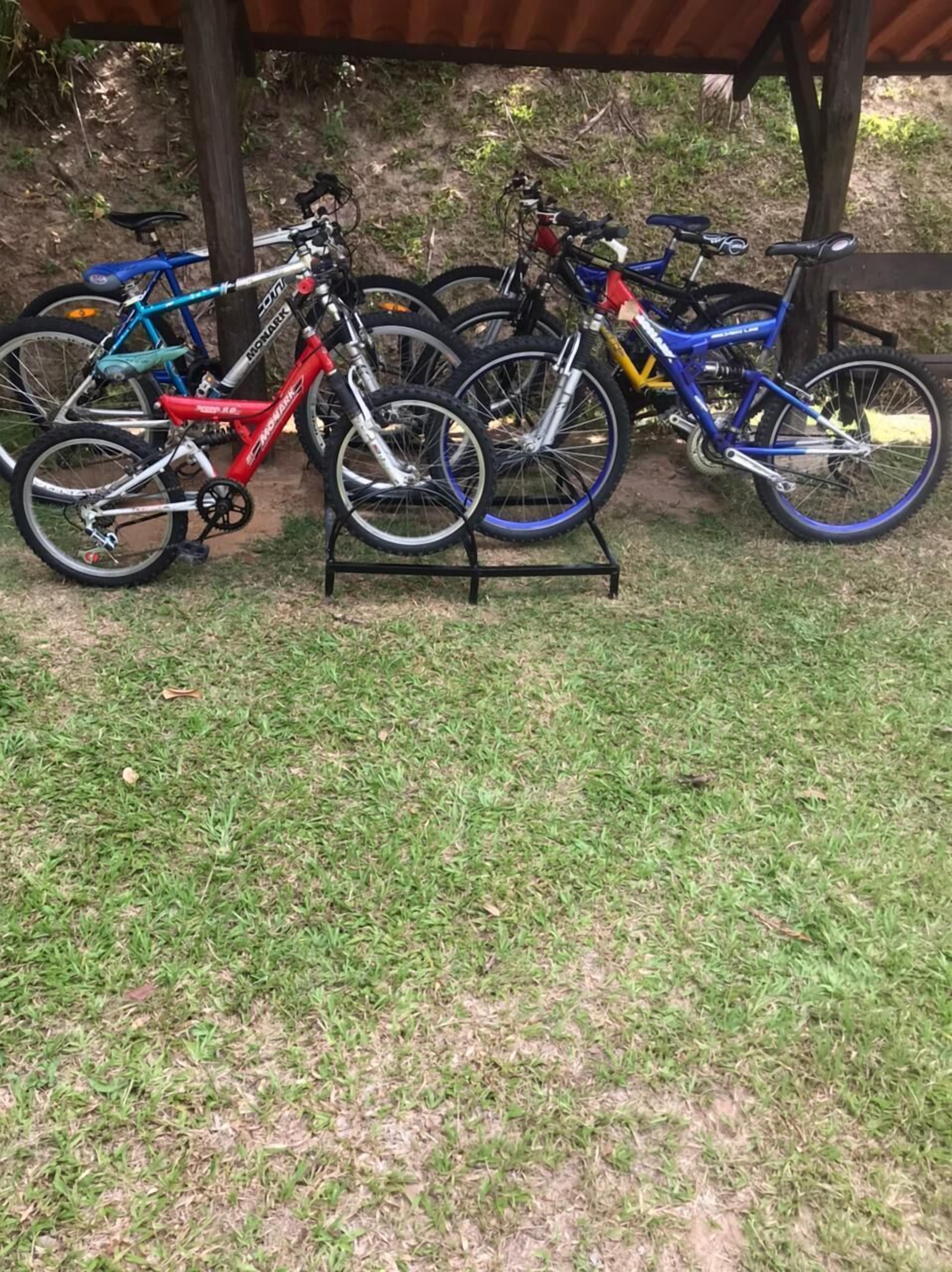 A covered outdoor area with bicycles parked on stands.