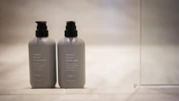 Deux flacons de produits de soins pour la peau sont posés sur une surface blanche.