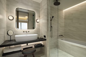 A modern bathroom with a large sink, mirror, and shower. - Hotel Toranomon Hills - The Unbound Collection by Hyatt (Tokyo)