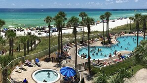 A resort with multiple swimming pools, a beach area, and a pier in the background. - Million dollar views, sleeps 10! Beachfront corner unit @ Grand Panama Resort! (Panama City Beach)