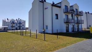 A modern building with multiple balconies and a flat roof. - Family Homes - Apartament Sea View (Wladyslawowo)