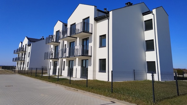 A modern multi-story residential building with balconies and a paved driveway. - Family Homes - Apartament Sea View (Wladyslawowo)