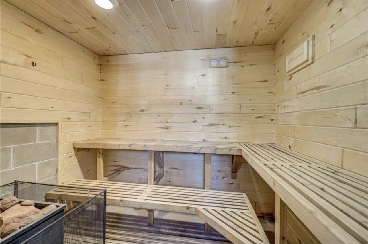 A sauna room with wooden walls and benches.