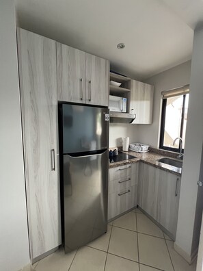 Fridge, coffee/tea maker, cookware/dishes/utensils