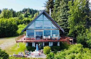 Enjoy the serene surroundings from the deck with outdoor seating.