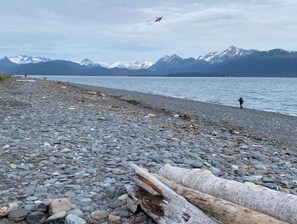 Guests can enjoy serene lakeside views and stroll along the pebbled shore.